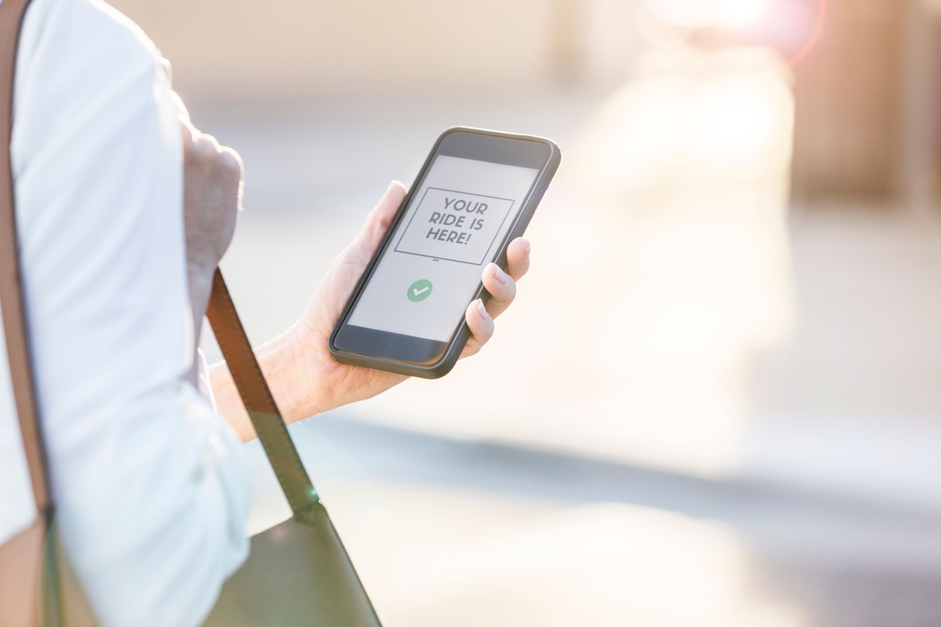 Businesswoman using mobile ride share app